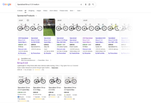Google search results for Specialized Sirrus X 2.0 Medium, showing sponsored products with different prices.